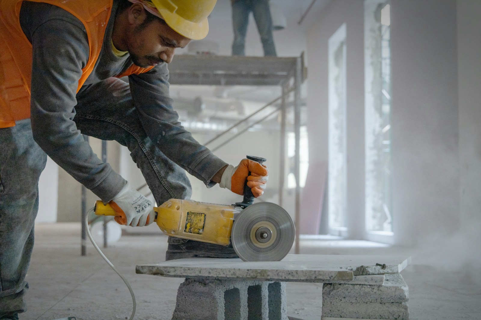 a man using a grinder on a piece of concrete